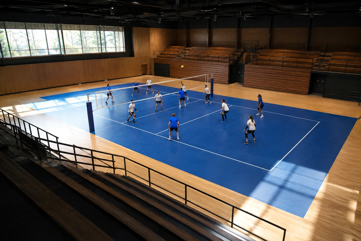 An elevated view of players and boundaries on an indoor volleyball court